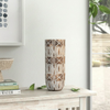Decorative vase with geometric pattern on a wooden surface
