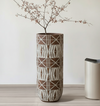 Decorative vase with geometric pattern on a wooden floor