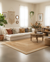 Cozy living room with a beige sofa, wooden coffee table, and decorative elements.