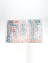 Multicolored abstract patterned rug on a white background