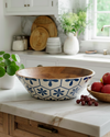 Kitchen counter with a decorative bowl, fruit, and a plant