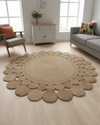 Round jute rug in a living room with light wood flooring and furniture.