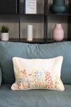 Decorative pillow with floral pattern on a blue sofa