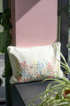 Decorative pillow with floral embroidery on a chair outdoors