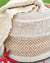 Stack of textured fabric rolls with geometric patterns on a neutral background