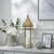 Decorative items including a lantern, vase with flowers, and spherical ornament on a shelf.