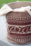 Textile basket with intricate patterns on a light background