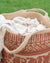 Textile with intricate patterns and white fabric on a green background. Handwoven_Ethnic_Printed_Jute_Basket_with_Handles_-_Red_3