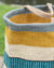 Woven basket with striped pattern on a blurred natural background