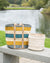 Two woven baskets on a wooden bench by a lake