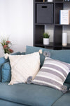 Blue sofa with decorative pillows in a living room setting