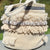 Beige woven basket with decorative elements on a blurred natural background