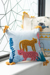 Decorative pillow with animal designs on a window sill