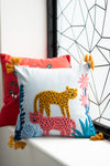 Decorative pillow with a colorful animal design on a white surface.