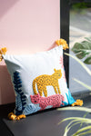 Decorative pillow with a leopard design on a surface with a pink background