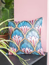 Decorative pillow with floral pattern on a black surface against a pink wall
