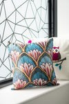 Decorative pillow with floral pattern on a window sill