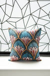 Decorative pillow with floral pattern on a white surface with geometric wall background