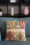 Decorative pillow with geometric pattern on a blue sofa