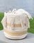 Woven basket with tassels and geometric patterns on a neutral background