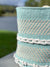 Close-up of a woven basket with a patterned design against a blurred natural background