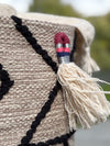 Textile with a tassel and geometric pattern