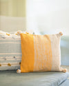 Decorative pillow with yellow and beige stripes on a sofa